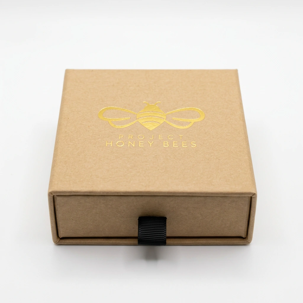 Luxury Gift Box in kraft paper with a gold foil Project Honey Bees logo and black ribbon pull