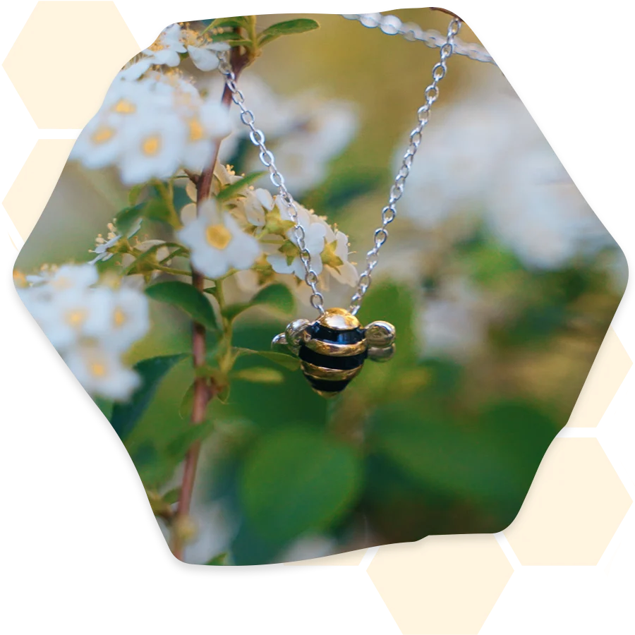 Adopt a Bee necklace on a flowering branch