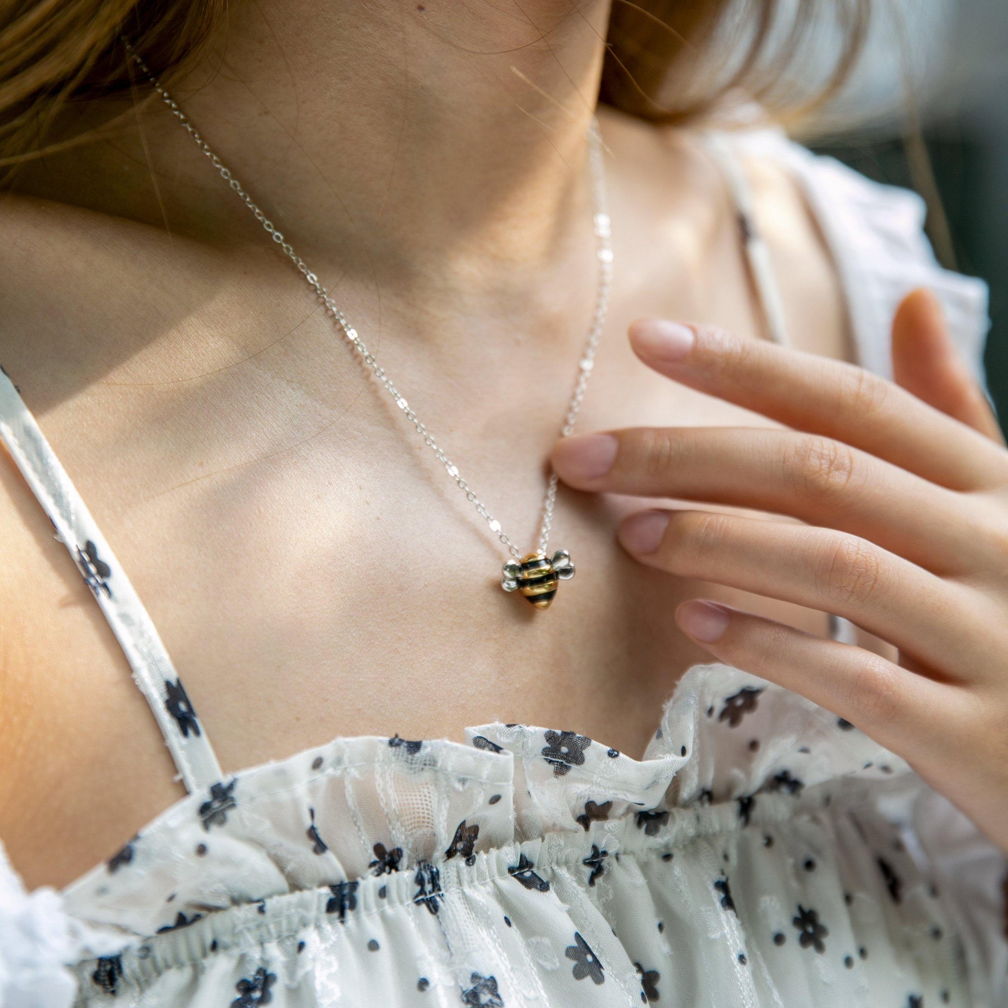 Woman wearing Adopt a Bee Necklace